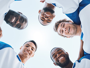 Image showing Portrait, sports and a soccer team in a huddle from a low angle against a blue sky for a game. Teamwork, collaboration and fitness with a football player group standing in a circle before a match