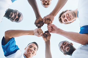 Image showing Sports, teamwork and fist bump circle for soccer for support, motivation and community on field. Diversity, team building and low angle portrait of football players ready for game, training and match