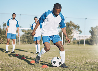 Image showing Sports, soccer and black man training with ball for practice, playing game and exercise on outdoor field. Motivation, energy and male football player kick, running and score goals for fitness workout