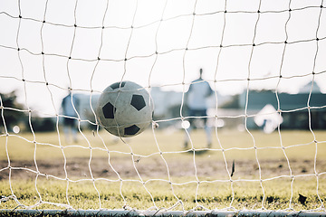 Image showing Sports, winner and soccer ball in net after goal, score and winning on field for training, practice and game match. Motivation, football club and players outdoors for fitness, exercise and workout