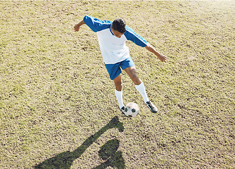 Image showing Football ball, soccer player and athlete doing sports cardio, training and exercise on a grass field. Kick, game and workout outdoor with fitness and running for wellness and health with energy