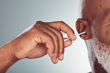 Image showing Ear, cleaning and hand isolated on studio background for cotton product, beauty and hygiene or senior man. Black person or model zoom for facial wellness, hearing and earbud cleaner mock up space