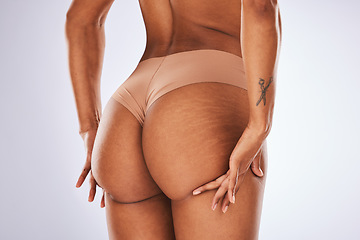 Image showing Cellulite, butt and underwear with a model black woman in studio on a gray background for body positivity. Stretch marks, real and natural buttocks with a female posing in lingerie from the back