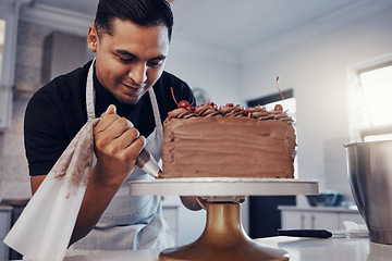 Image showing Piping, bakery and chef baking a cake with chocolate and pastry in a kitchen and is happy decorating his recipe. Food, dessert and cook preparing a sweet meal by a Brazil man and adds cream