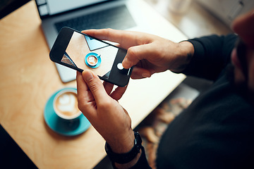 Image showing Hands, phone and photo of coffee at cafe for social media, post or photography at an indoor shop. Hand of man taking picture of hot beverage, vlog or cup with mobile smartphone by small table