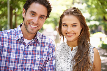 Image showing Park, portrait and couple on a outdoor date with happiness and love together in nature. Sunshine, vacation and fun with a smile in summer on holiday feeling relax in the sun with blurred background