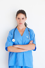 Image showing Portrait, woman and doctor with arms crossed standing isolated against a white studio background. Confident female medical professional, expert or nurse with stethoscope for healthcare or profile