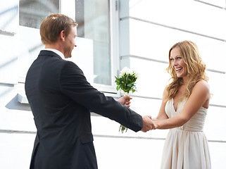 Image showing Man, flowers and woman with smile for valentines day, relationship or celebration for date. Happy couple holding hands with white roses or bouquet to celebrate anniversary or special month of love