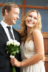 Image showing Love, romance and couple with flowers for valentines day, luxury date with smile, boyfriend and girlfriend. Flower bouquet, man and woman dressed in elegant clothing for special fancy valentine event