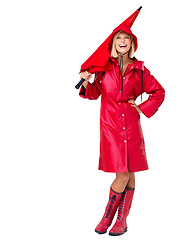 Image showing Portrait, woman and umbrella with raincoat, cover and happiness with lady isolated on white studio background. Mockup, female and lady with winter outfit, boots and shelter from storm or on backdrop