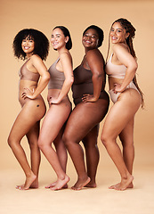 Image showing Diversity women, skin and body positivity portrait of friends together for inclusion, beauty and power. Underwear model group on beige background with cellulite, pride and motivation for self love