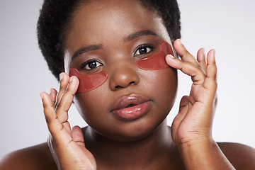 Image showing Black woman, face and portrait with eye patch for skincare, healthy skin and glow isolated on studio background. Hands, shine and natural cosmetics, dermatology and facial mask with beauty care