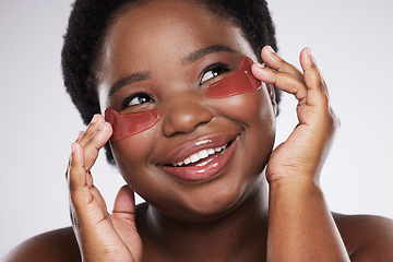 Image showing Black woman, face and happy with eye patch for skincare, healthy skin and glow isolated on studio background. Hands, shine and natural cosmetics, dermatology and facial care with beauty and smile