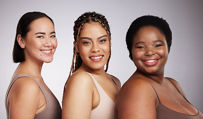 Image showing Portrait, skin and diversity with woman friends in studio on a gray background together for skincare beauty. Face, makeup and natural with a female model group posing to promote support or inclusion