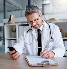 Image showing Man, writing on checklist and doctor with phone in hospital for healthcare, information or research. Telehealth technology, medical smartphone and mature physician with mobile, clipboard or documents