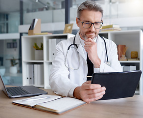 Image showing Thinking doctor, tablet and man in hospital for telehealth, online consultation or healthcare. Medical technology, wellness ideas or mature male physician with digital touchscreen for health research