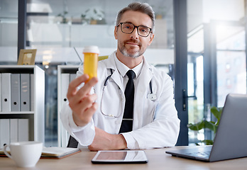 Image showing Medical doctor, portrait and pills in hospital for healthcare, wellness and health in clinic. Medicine, medication and male physician holding medicinal drug product or prescription for healthy cure.