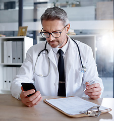 Image showing Man, office and doctor with phone in hospital for healthcare, information or research. Telehealth technology, medical smartphone and mature physician with mobile, clipboard or checklist documents.