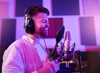 Image showing Musician, singer or man on neon microphone, karaoke studio or theatre practice in night booth recording. Singing, person or pop artist on production, voice media or sound performance in light theater