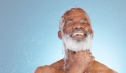 Image showing Water, splash and mockup with black man and shower for skincare, hygiene and dermatology. Wellness, spa and facial with senior model cleaning in blue background studio for health, luxury or hydration