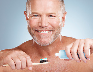 Image showing Portrait, toothpaste or old man brushing teeth with dental products in a healthy oral hygiene grooming in studio. Face, smile or happy senior guy cleaning mouth with a natural bamboo wood toothbrush