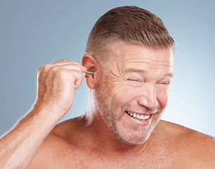 Image showing Man, ear bud and grooming in skincare, cosmetics or hygiene products against a gray studio background. Male person cleaning ears for body care or self love in clean beauty, health and wellness