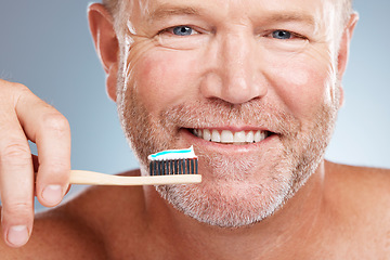 Image showing Portrait, toothpaste or old man brushing teeth with a product for healthy oral or dental hygiene in studio. Face, smile or happy senior person cleaning mouth with a natural bamboo wood toothbrush