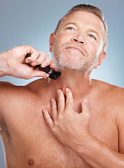 Image showing Grooming, cleaning and man with razor for beard for wellness, healthy skin and hygiene on blue background. Beauty, skincare and face of male with barber shaver for facial, haircare and self care