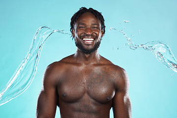 Image showing Water splash, portrait and black man isolated on blue background for face cleaning, body shower and skincare. Strong, beauty and happy model or person muscle with studio headshot, washing or hygiene