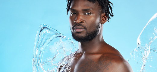 Image showing Banner, shower and portrait of a black man with a water splash isolated on a blue background. Cleaning, beauty and African model for grooming treatment, hygiene and care of body on a studio backdrop