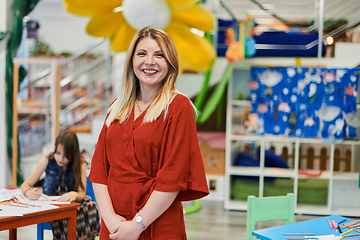 Image showing Portrait of a teacher in a preschool institution, in the background of the classrooms