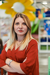 Image showing Portrait of a teacher in a preschool institution, in the background of the classrooms