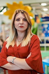 Image showing Portrait of a teacher in a preschool institution, in the background of the classrooms