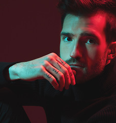 Image showing Man, fashion and studio portrait with red light for clothes, hand tattoo and luxury style on dark background. Face of aesthetic model person with turtle neck, art and cosmetic for inspiration for men