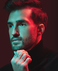 Image showing Idea, fashion and red with a handsome man model in studio on a dark background for contemporary beauty. Face, thinking and art with a young male posing indoor to promote trendy clothes or style