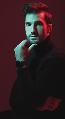 Image showing Man, fashion and studio portrait with red lights for clothes, beauty and luxury style on dark background. Face of aesthetic model person with turtle neck, art and cosmetics for inspiration for men