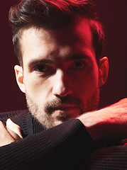 Image showing Portrait, beauty and red with a handsome man model in studio on a dark background for contemporary fashion. Face, art and serious with a young male posing indoor to promote trendy clothes or style