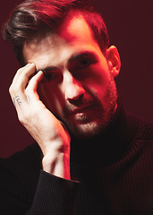 Image showing Portrait, fashion and red with a handsome man model in studio on a dark background for contemporary beauty. Face, dramatic or art with a handsome male posing indoor to promote trendy clothes or style