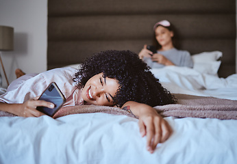 Image showing Relax, smile and phone with black woman at sleepover for communication, internet or contact. Happy, online dating and texting with girl and friends in bedroom with technology, digital or social media