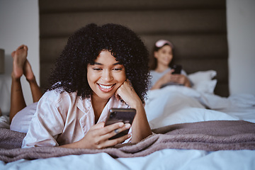 Image showing Contact, phone and smile with black woman at sleepover for communication, internet or online dating. Happy, relax and texting with girl and friends in bedroom with technology, digital or social media