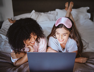 Image showing Laptop, movie and happy with friends in bedroom for sleepover, bonding and streaming. Technology, internet and relax with women lying on bed at night for cinema, subscription and film entertainment