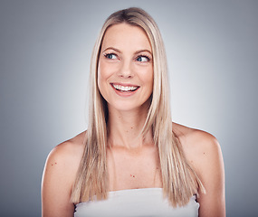 Image showing Woman, thinking and hair care aesthetic with mockup in a studio for wellness and beauty. Facial, smile and happy model with gray background and mock up ready for dermatology and spa treatment