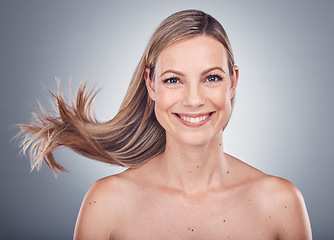 Image showing Woman in portrait, happy and face with hair in air, beauty and keratin treatment, cosmetic care isolated on studio background. Model smile, glow and hairstyle shine, natural cosmetics and skincare