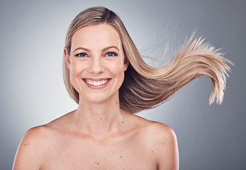 Image showing Woman in portrait, face with hair in air, beauty and keratin treatment, cosmetic care with smile isolated on studio background. Happy model, glow and hairstyle shine, natural cosmetics and skincare