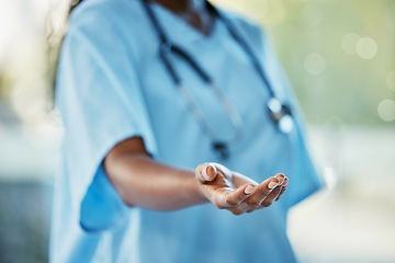 Image showing Healthcare, doctor or nurse with helping hand giving support, health care and volunteer work in hospital in Africa. Black woman medical worker, stethoscope and hands in trust working charity clinic.