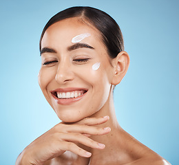 Image showing Beauty cream, skin and face of a happy woman with hand for dermatology, cosmetics and natural glow. Aesthetic model person with natural spa facial self care for health and wellness on blue background