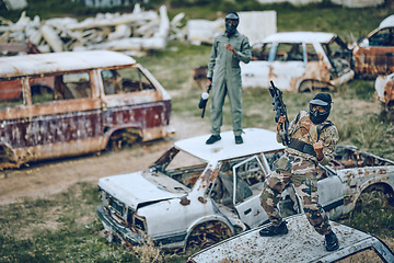 Image showing Paintball, winner and celebration with a sports man on a car in a battlefield during army training for the military. War, victory and motivation with a male soldier celebrating winning during a game