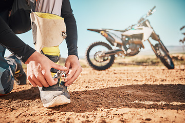 Image showing Extreme, motorcycle and man tying laces in nature for adventure, holiday and race in the countryside. Start, travel and biker ready with shoes for a journey on a motorbike on a dirt road for freedom