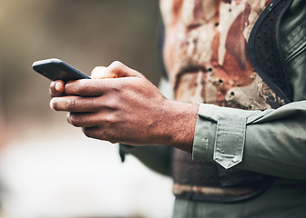 Image showing Phone, camouflage and solider at war on social media or browsing internet, app or website at military or army. Hands, combat and texting on battlefield, competition or match with game safety gear