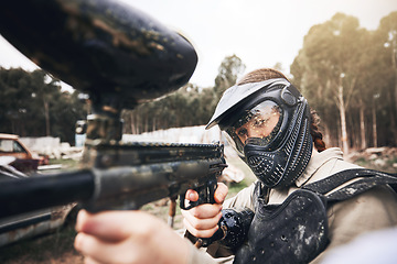 Image showing Paintball, gun and aim with a sports woman training for the military or army during a war and combat game. Exercise, warrior and marker with a female athlete or soldier on a battlefield simulation